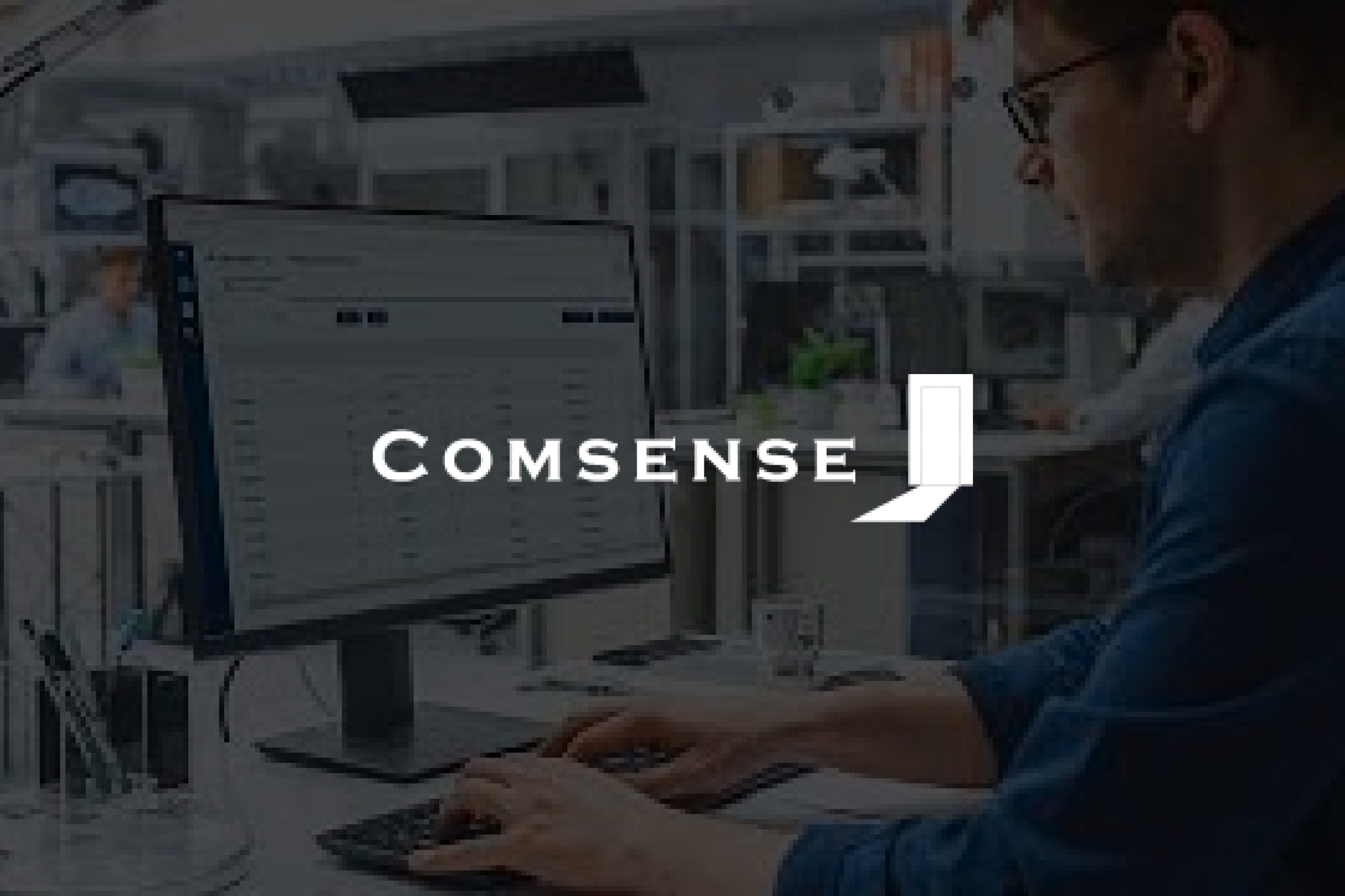 A person sitting and typing on keyboard of desktop with the brand logo overlaid.