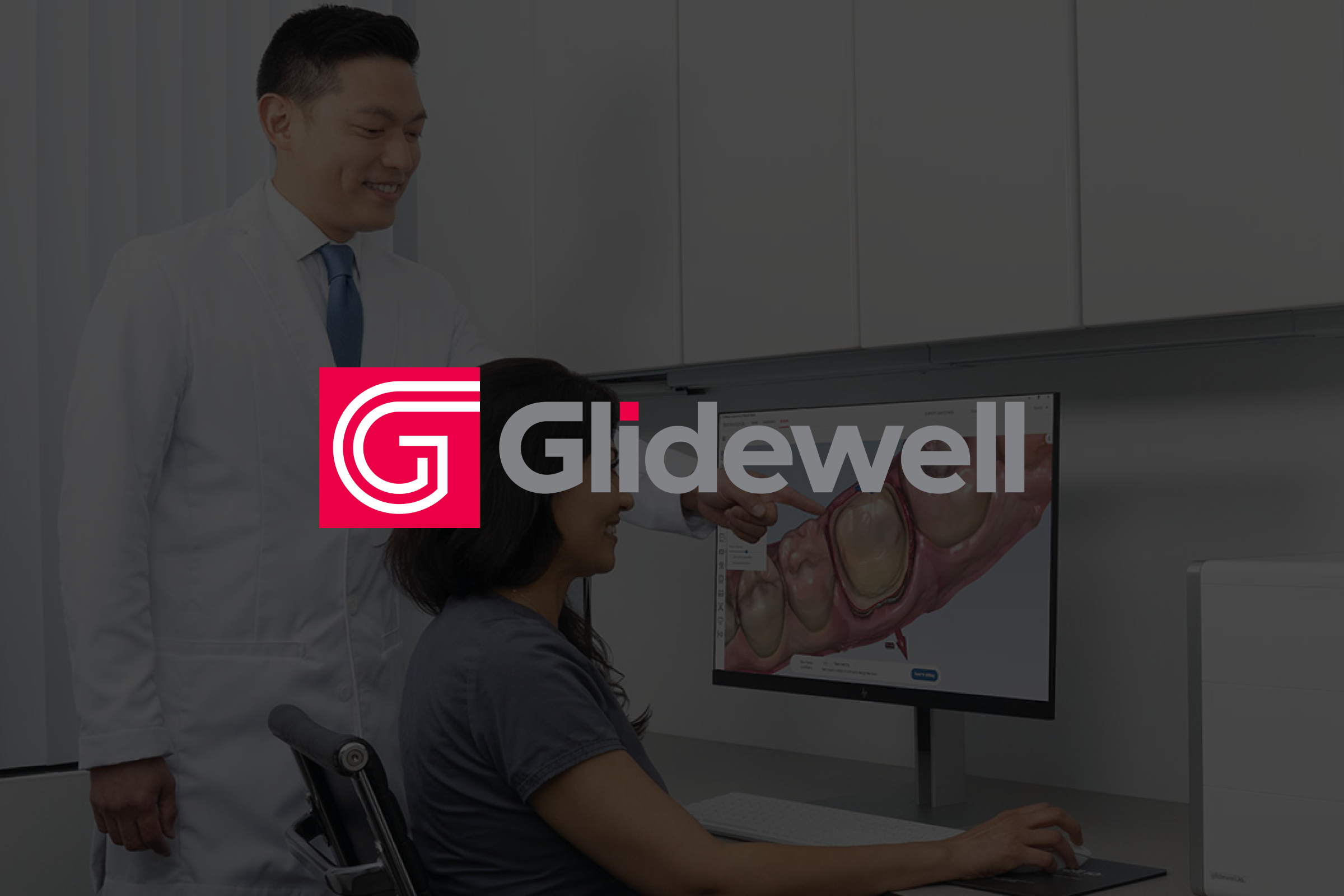 A doctor and a nurse looking at the desktop screen displaying teeth cavities with brand logo overlaid.