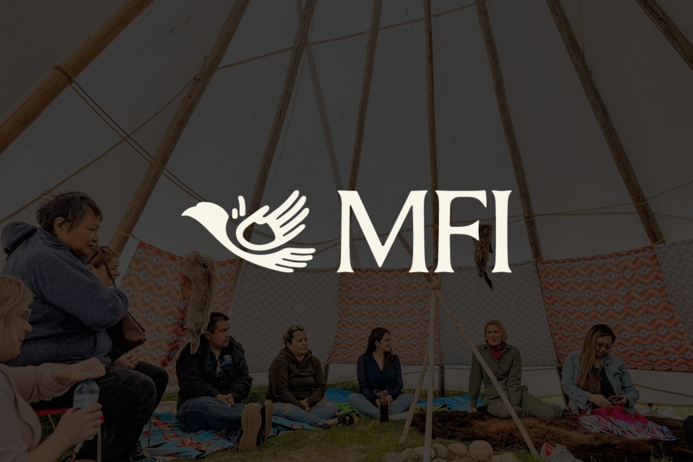 Group of people sitting inside a tent in a circle while having a conversation with the brand logo overlaid.